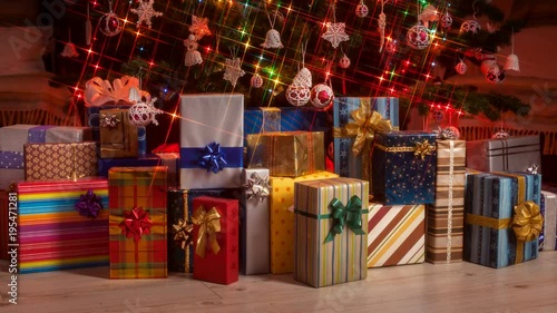 Gifts appearing under the christmas tree with twinkling lights - stop motion animation