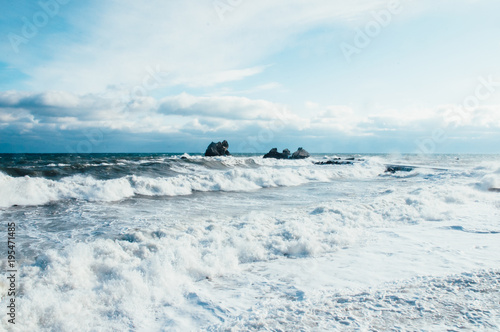 Sea storm waves from southern coast Crimea. Rocks in the sea, sunny day