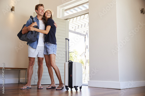 Couple Arriving At Summer Vacation Rental