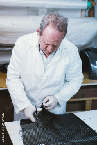  59  year  old man working at the fiber workshop photo