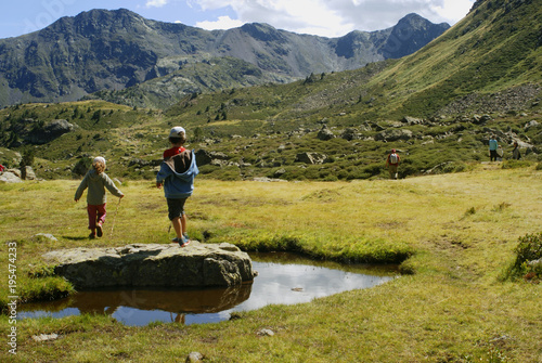 Children walking in the mountains in a sunny day