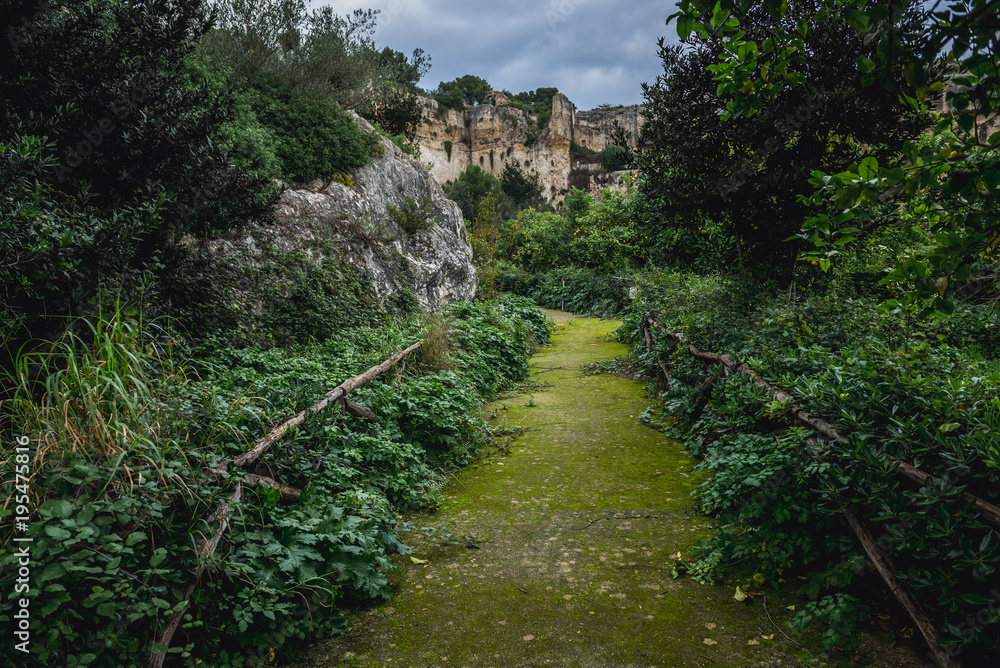 Alleyway in ancient quarry of Neapolis Archaeological Park in Syracuse, Sicily Island of Italy