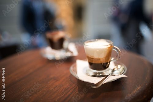 Cappuccino served on a wooden bistro table photo