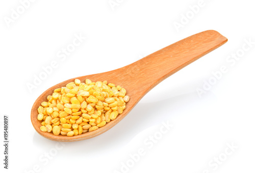 Green beans seeds in wood spoon on white background