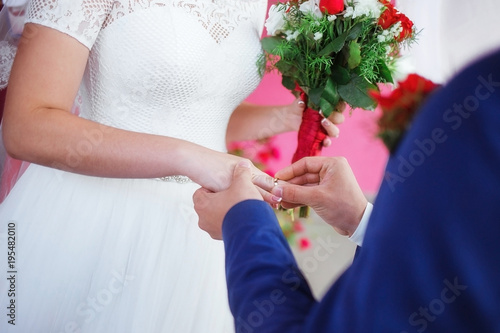 The moment when the newlyweds exchange rings and swear an oath. Closeup. photo