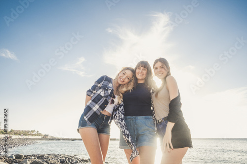 Three young beauty women at the beach join the summer