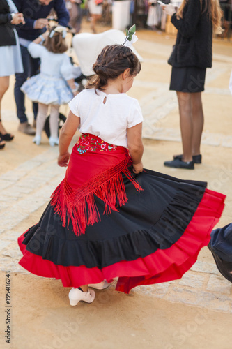 Rear view child dancing wearing typical spanish regional costume. Flamenco. Andalucia. Spain