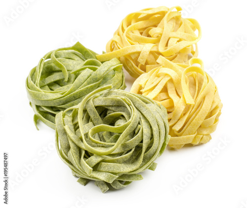 Fettuccine raw pasta spinach and classic isolated on white background four pieces.