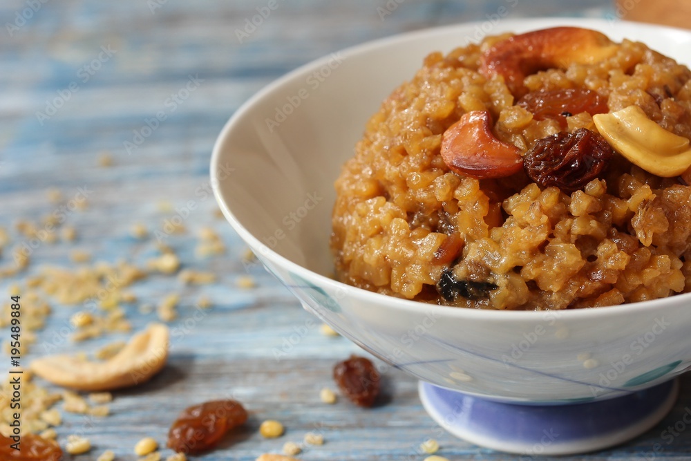 Homemade sweet pongal topped with raisins nuts, selective focus Homemade sweet pongal topped with raisins nuts, selective focus