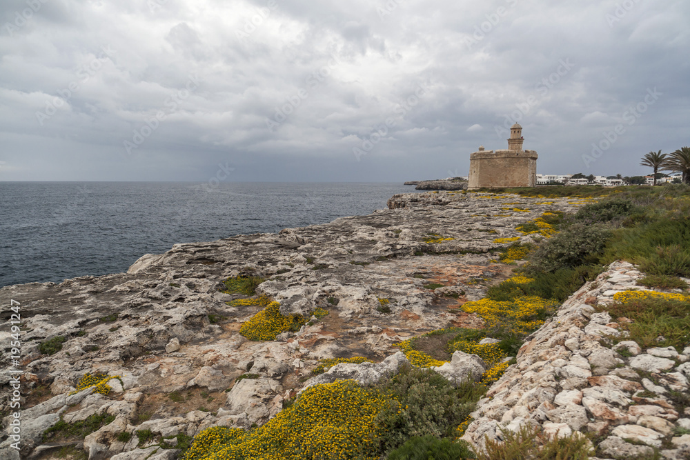 Cliffs and Castle or tower, Castell San Nicolau in balearic town of Ciutadella, Minorca island, Balearic islands, Spain.