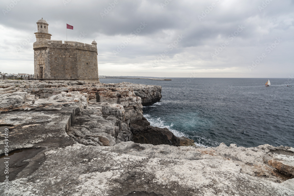 Cliffs and Castle or tower, Castell San Nicolau in balearic town of Ciutadella, Minorca island, Balearic islands, Spain.