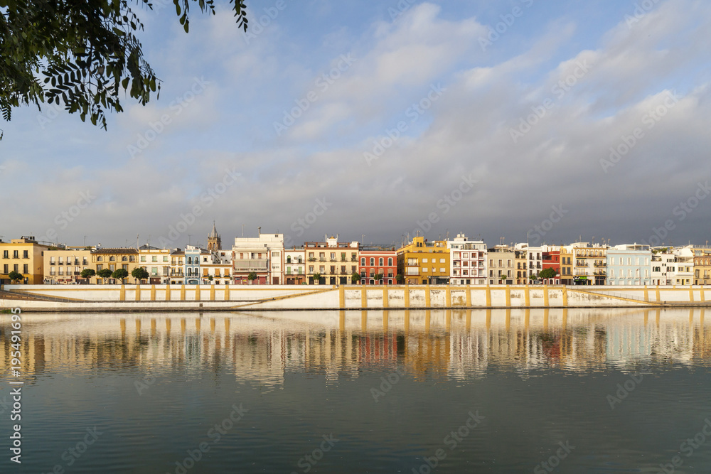 Panoramic view of river and colored houses of Barrio de Triana, quarter. Sevilla, Andalucia, Spain.