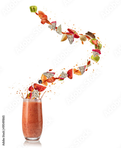 Smoothie drink with fruit flying ingredients on white
