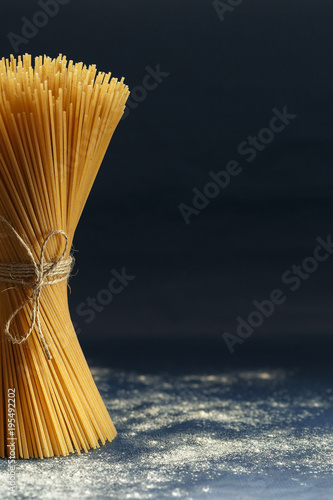 Uncooked pasta spaghetti on a blue background
