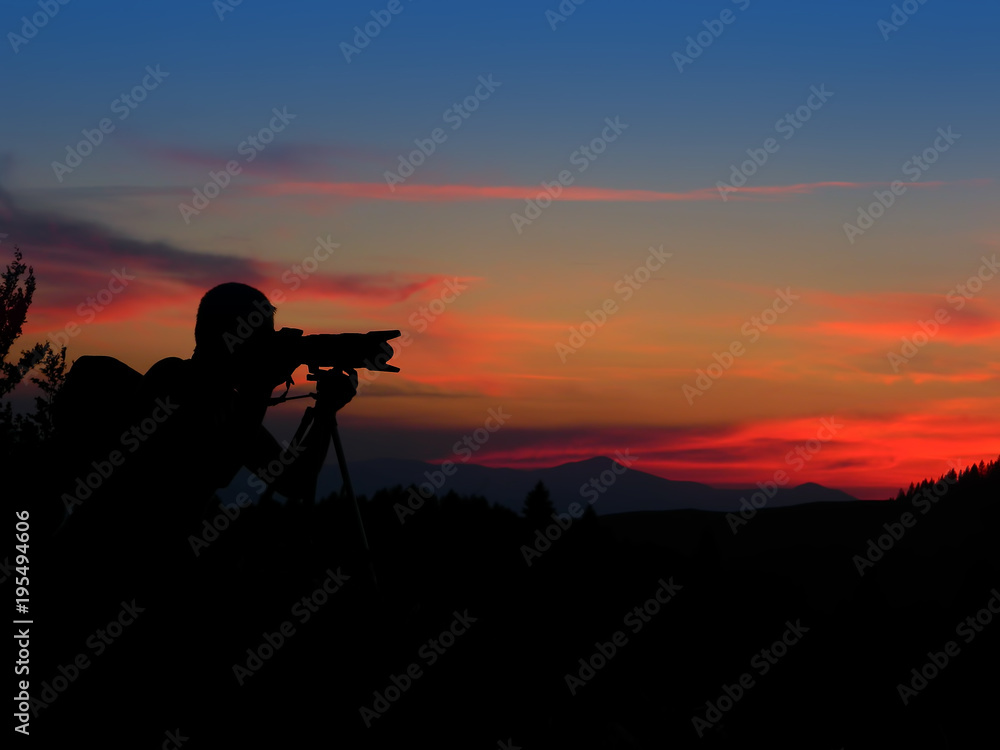 silhouette of photographer taking photos after sunset