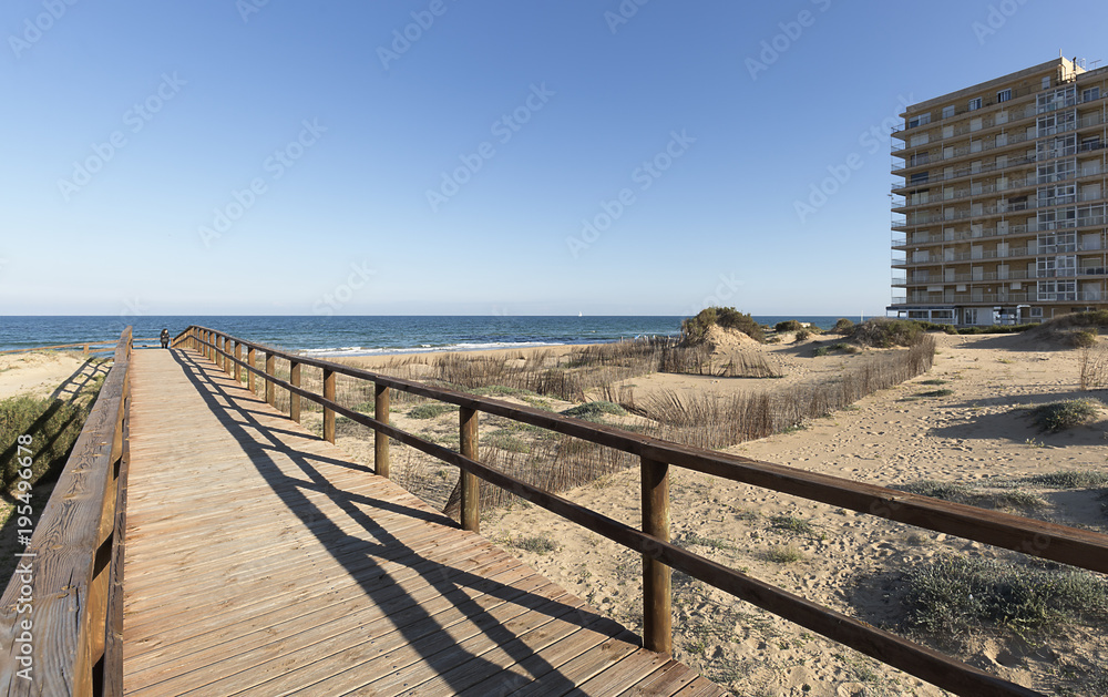 Fototapeta premium Wooden walkway that gives access to one of the beaches of Arenales del Sol.