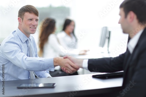 handshake business partners at your Desk