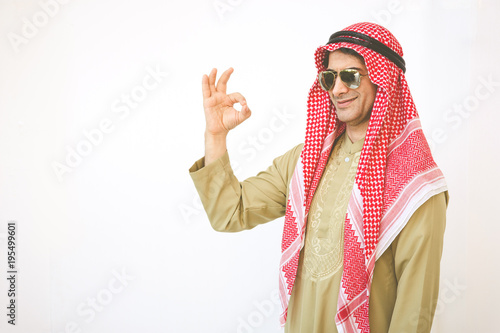 Arab businessman pointing up ok hand sign