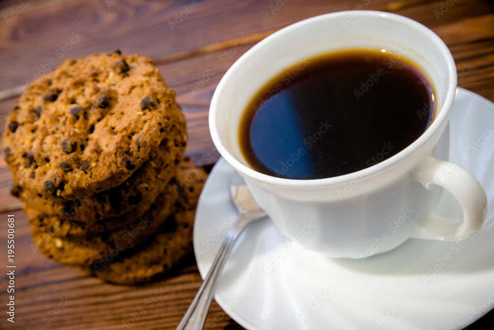 A cup of hot coffee stands on a wooden table A cup of hot coffee stands on a wooden table