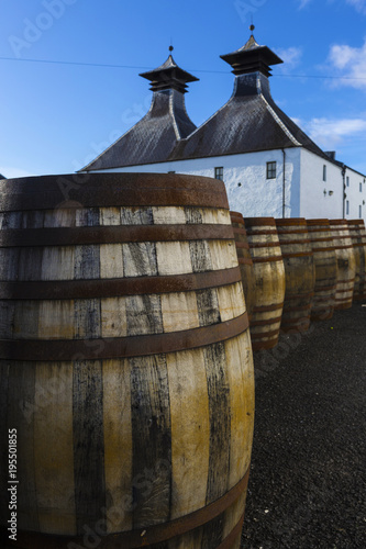  Traditional white painted building with black double tower roof of Scottish Whisky distillery