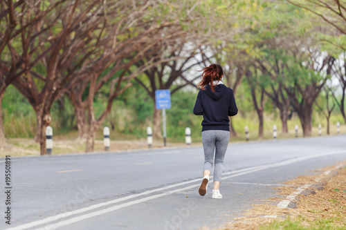 young fitness woman running in park