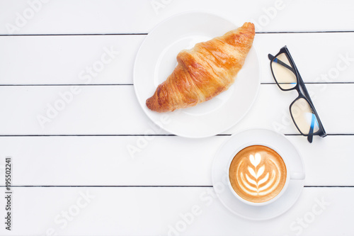 phone croissant coffee view from above wooden white background