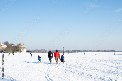 Family school run in the snow at Blackheath
