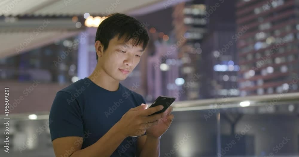 Asian man use of mobile phone at night Asian man use of mobile phone at night