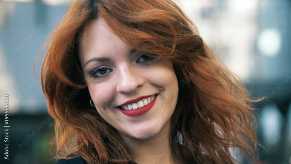 Close up on Beautiful sexy red hair woman smiling at camera Close up on Beautiful sexy red hair woman smiling at camera