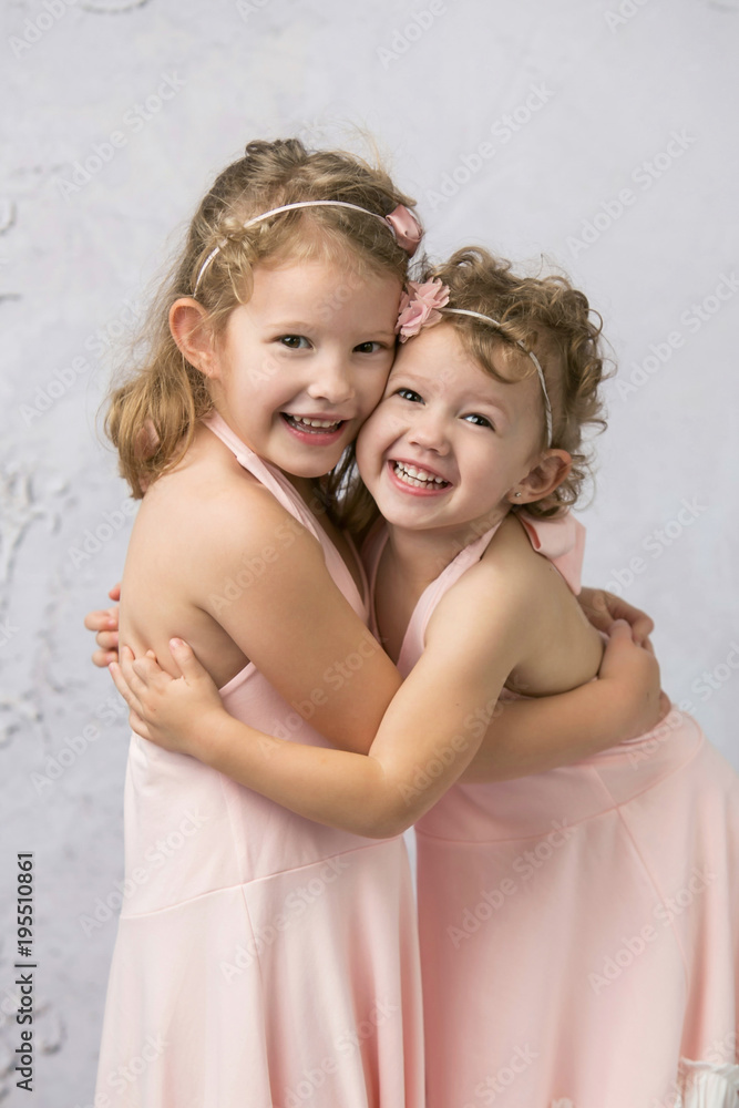 Happy Sisters in Pink Dresses Smiling Girls Happy Sisters in Pink Dresses Smiling Girls