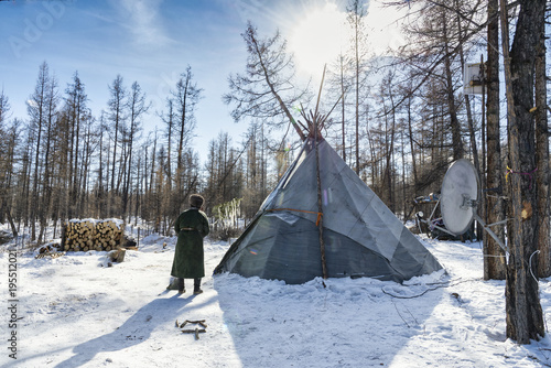 man in Mongolian robe near the tent camp Tsaatans