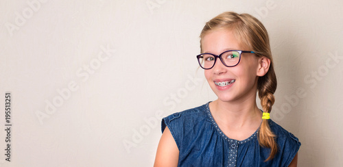 Fototapeta Naklejka Na Ścianę i Meble -  Health, education and people concept. Closeup portrait of happy teen girl in braces and eyeglasses.