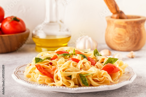 Pasta with tomato sauce served with basil