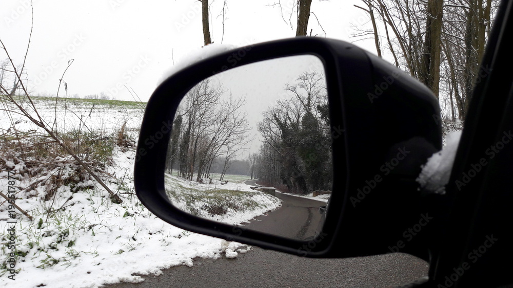 Specchietto retrovisore dell'auto in un paesaggio invernale