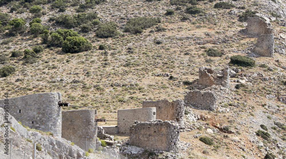 Ruins of ancient Venetian windmills built in 15th century, Lassithi Plateau, Crete, Greece.  Most typical characteristic of the Plateau. In the past, they numbered thousands making up a magnificent la