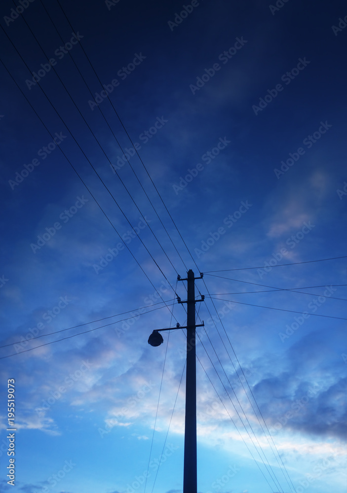 Vertical power line post cloudscape background
