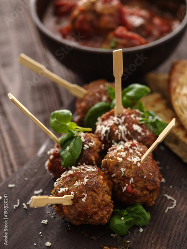 Delicious homemade meat balls with tomato sauce on skewers.
