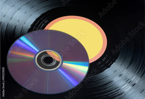 Vinyl records and CDs disks close up.