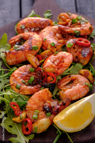 Large grilled BBQ shrimp with sweet chili sauce, green onion and lemon.