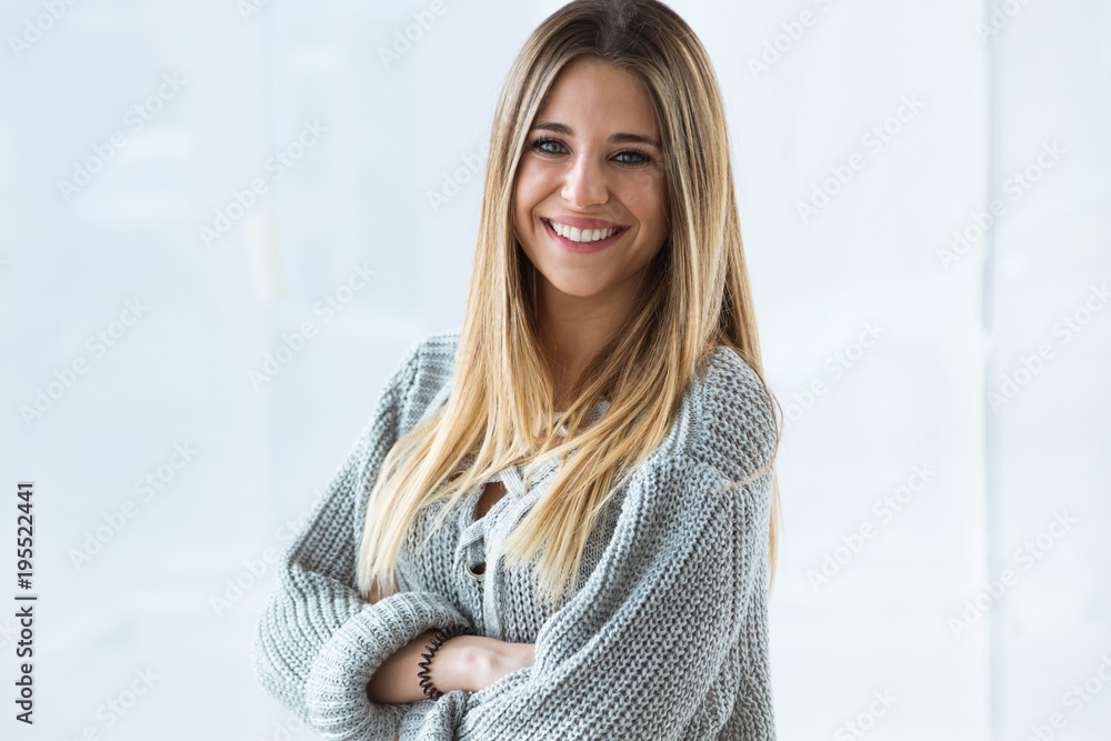 Beautiful young woman looking at camera at home. Beautiful young woman looking at camera at home.