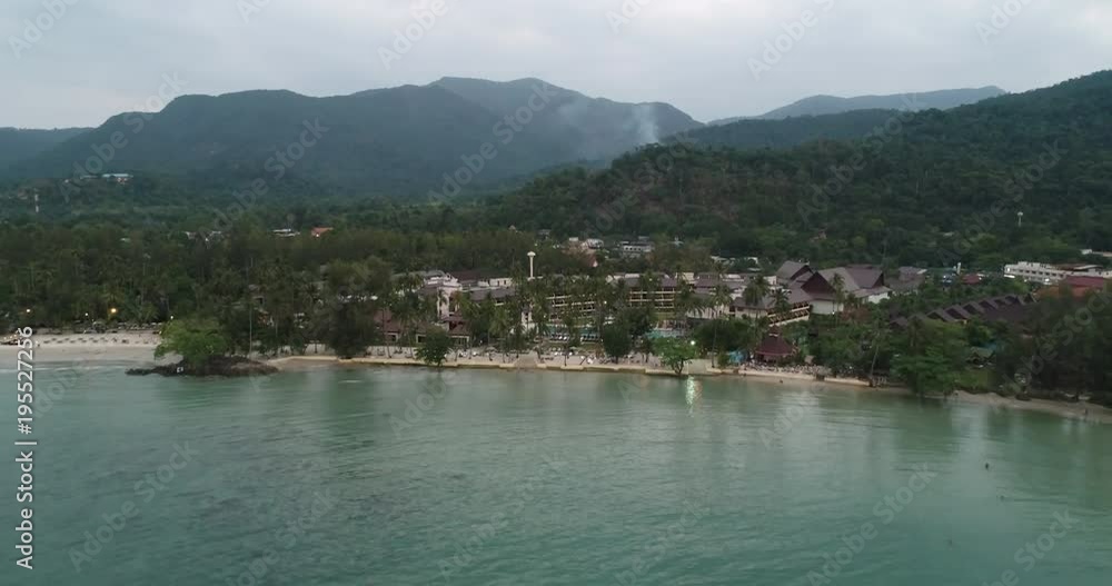 AerialNatural with city and Blue sea and the beach with mountain and vapor background,In the Sunset time at Koh Chang in Thailand. AerialNatural with city and Blue sea and the beach with mountain and vapor background,In the Sunset time at Koh Chang in Thailand.