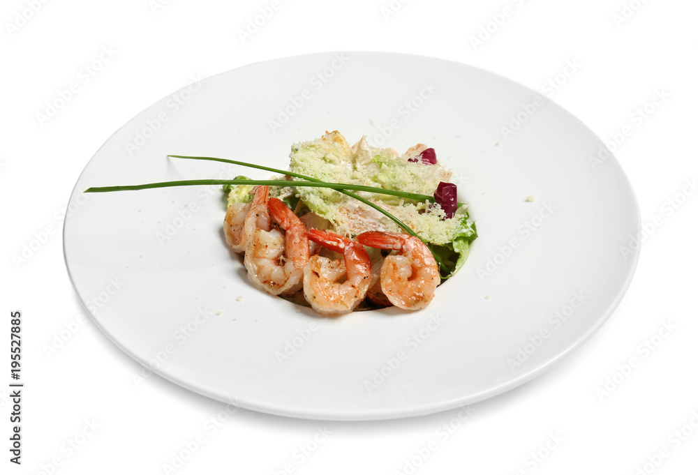 Delicious Caesar salad with shrimps in plate on white background Delicious Caesar salad with shrimps in plate on white background