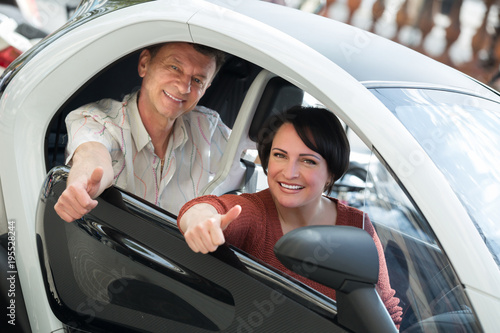 Couple standing near twizy electric photo