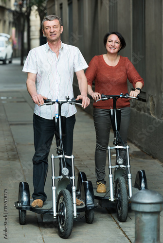 Mature couple staying with electric bikes photo