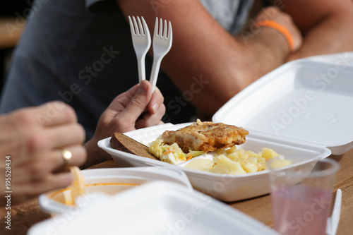 Close up of man with food in plastic container