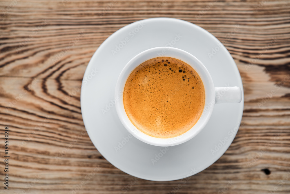 Coffee cup top view on wooden table background Coffee cup top view on wooden table background