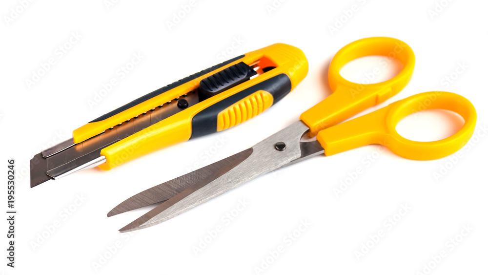 Yellow scissors and cutter knife isolated on white background Yellow scissors and cutter knife isolated on white background