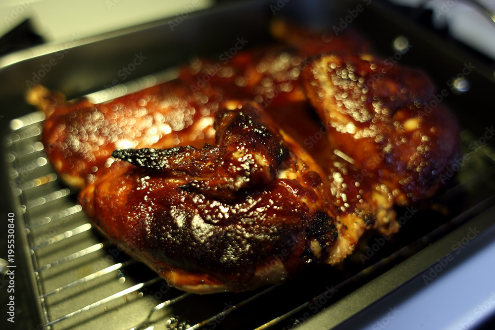 Baked BBQ Spatchcock chicken cooling on the stove.