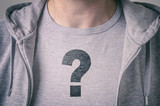 Boy with question mark on T-shirt. Conceptual image of confusion and identity issues.