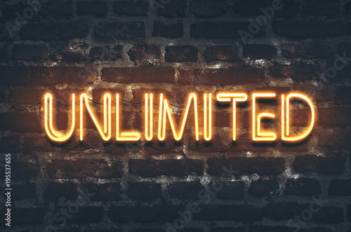 Photos Unlimited neon sign on dark brick wall background